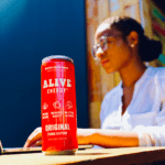 Woman working out with red Alive Energy can in foreground
