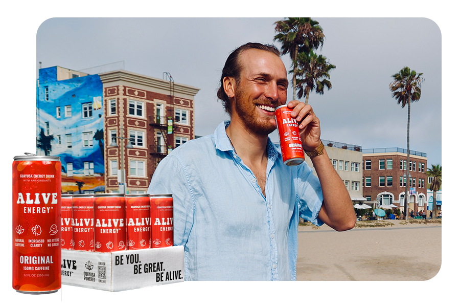 Man smiling with red Alive Energy can in hand